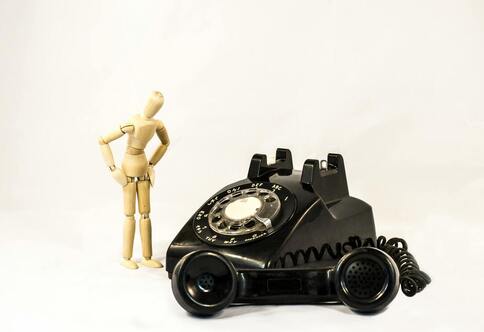 wooden man doing telephone therapy
